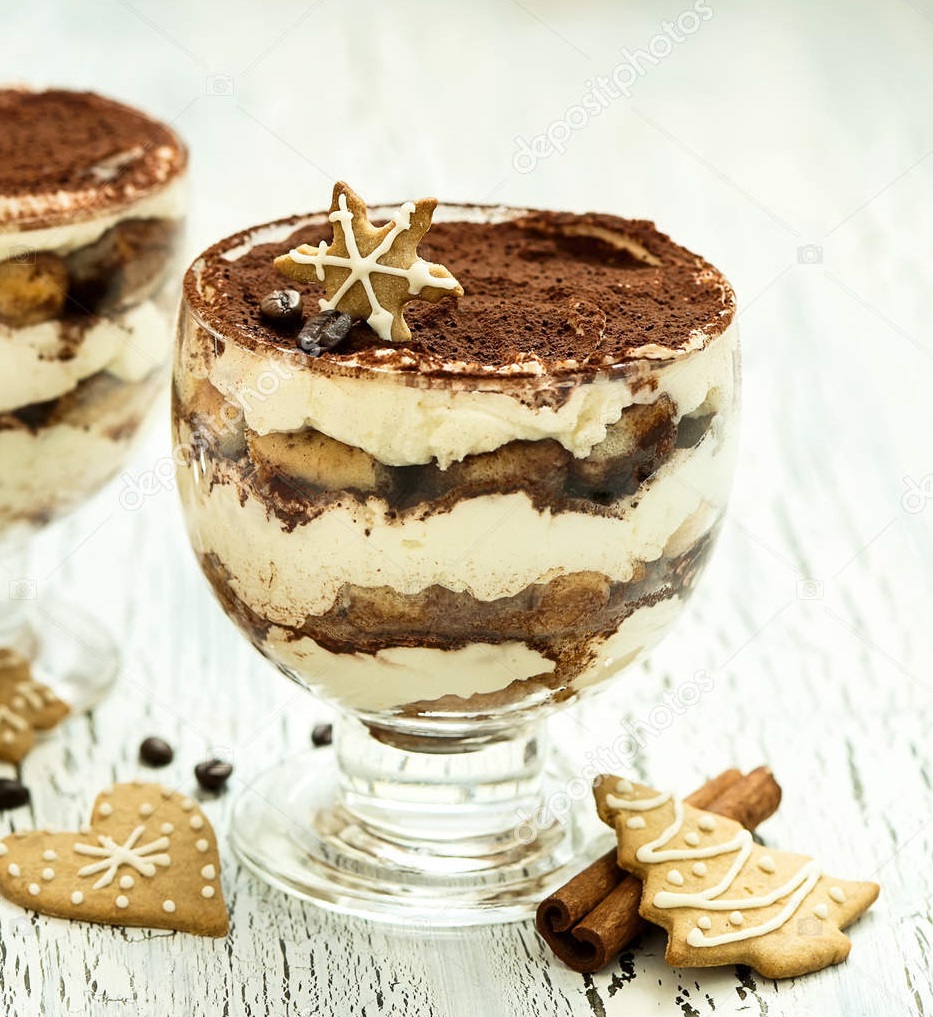 Italian chocolate and cream dessert tiramisu in glass with homemade christmas cookies, sweet food on white background