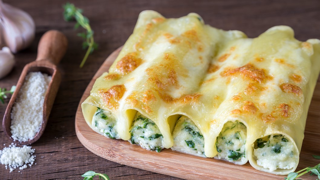 Cannelloni with ricotta and spinach on the wooden board